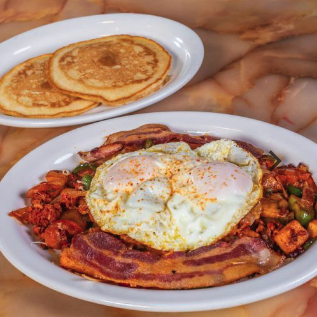 Breakfast plate with eggs, bacon, and pancakes at El Paisano Des Moines