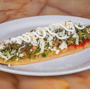Mexican huarache topped with salsa verde and cheese at El Paisano Des Moines