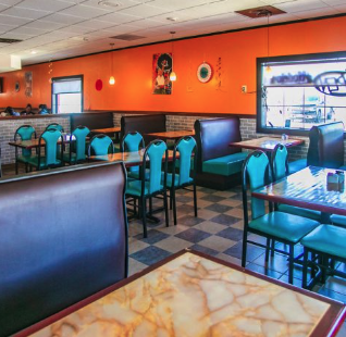 Cozy booth seating inside El Paisano Mexican Food and Bakery in Des Moines